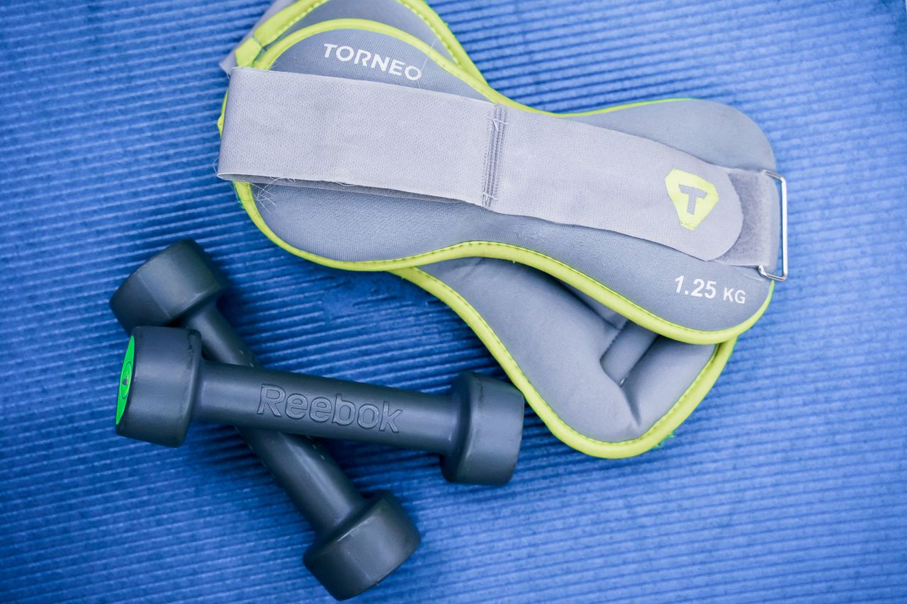 The Art of Drawing Readers In: Your attractive post title goes here From above of modern dumbbells and leg weight belts placed on blue fitness mat in studio
