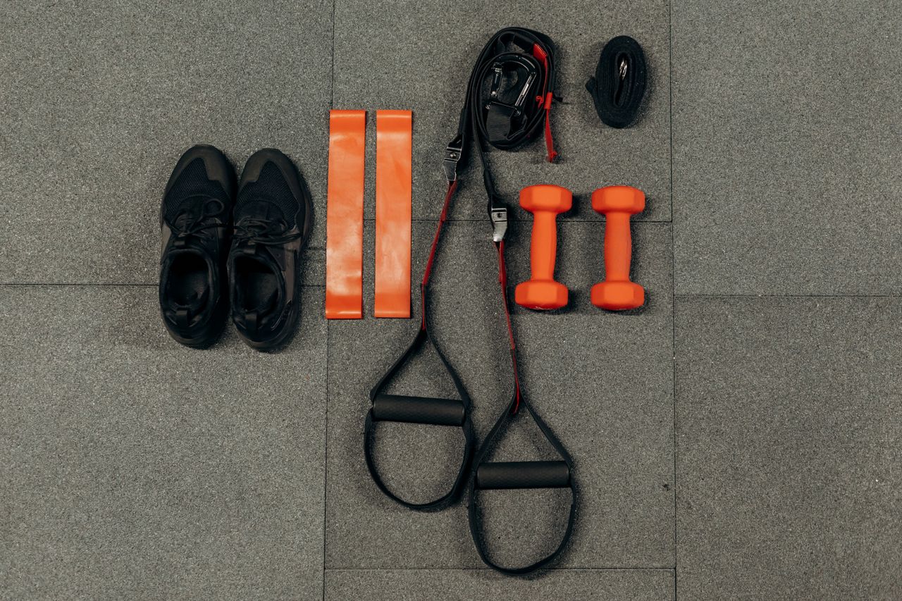 Crafting Captivating Headlines: Your awesome post title goes here Flat lay of fitness gear including dumbbells, sneakers, and resistance bands for a home workout.